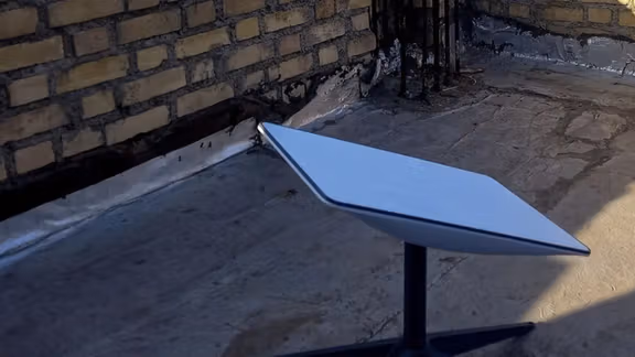 Starlink satellite dish installed on a rooftop in Iran, providing unfiltered internet access despite government restrictions and censorship.