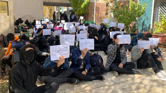 Students holding signs with detained classmates' names at K. N. Toosi University, 2022