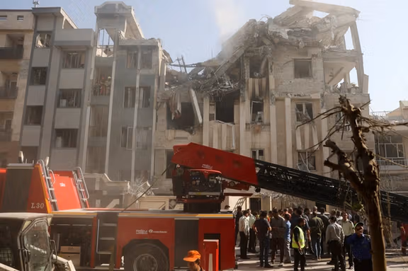 Rescuers work at the scene of a damaged building in the aftermath of Israeli strikes, in Tehran, Iran, June 13, 2025.