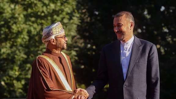 Iranian Foreign Minister Hossein Amir-Abdollahian (right) shakes hands with his Omani counterpart Sayyid Badr Albusaidi upon his arrival in Tehran on July 17, 2023.