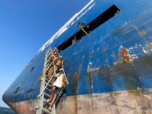 People walk down a ladder after they toured the Galaxy Leader commercial ship, seized by Yemen's Houthis last month, off the coast of al-Salif, Yemen December 5, 2023.