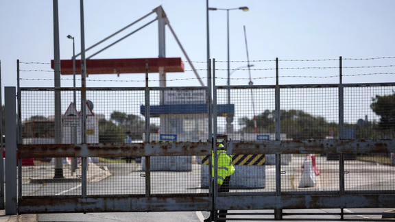 A police officer closes the entrance of RAF Akrotiri, a British sovereign base in Cyprus, which was hit by a drone overnight on March 2, 2026.