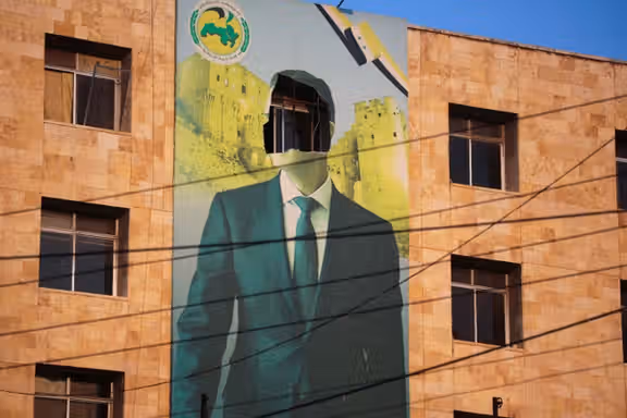 A view shows a damaged poster of Syria's President Bashar al-Assad in Aleppo, after the Syrian army said that dozens of its soldiers had been killed in a major attack by rebels who swept into the city, in Syria November 30, 2024.