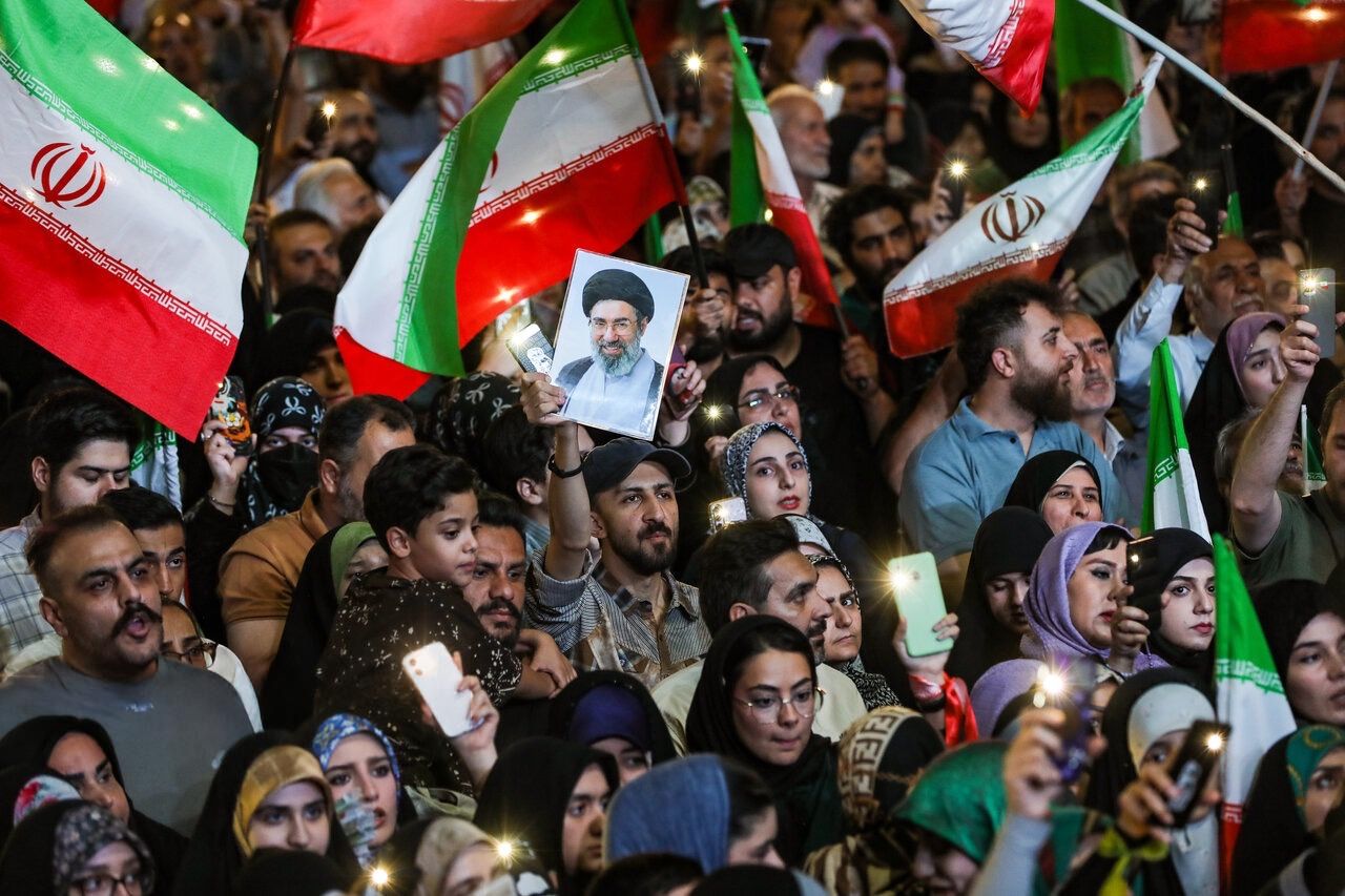 Supporters of the Islamic Republic wave Iranian flags during the 200th consecutive night of pro-state rallies in Tehran, September 17, 2026.