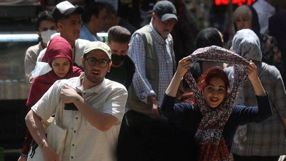 An Iranian woman walks on a street amid the implementation of the new hijab surveillance in Tehran, Iran, April 15, 2023.