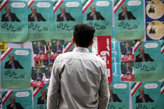 A man looks on parliamentary election campaign posters in Tehran, Iran February 19, 2020.