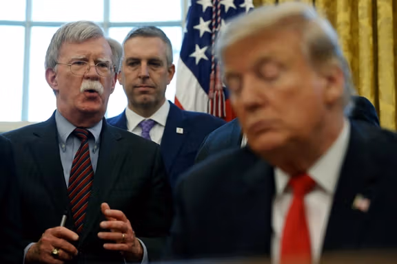 US President Donald Trump listens as his national security adviser John Bolton speaks during a presidential memorandum signing for the "Women's Global Development and Prosperity" initiative in the Oval Office at the White House in Washington, US, February 7, 2019.