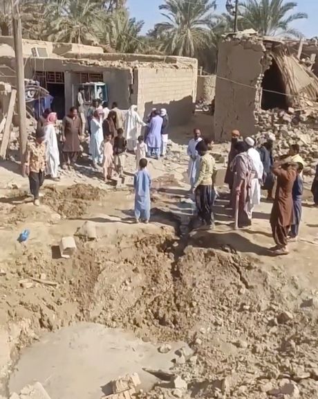 People gather near rubble in the aftermath of Pakistan's military strike on an Iranian village near Saravan, Sistan and Baluchestan Province, Iran, January 18, 2024.