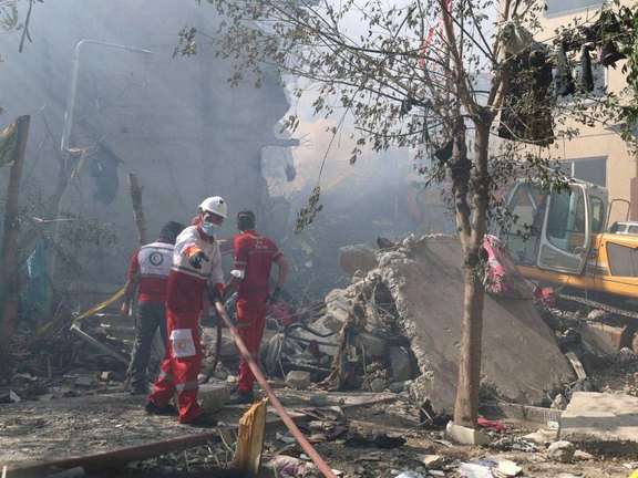 Rescuers work at the site of a damaged building, in the aftermath of Israeli strikes, in Tehran, Iran, June 13, 2025.