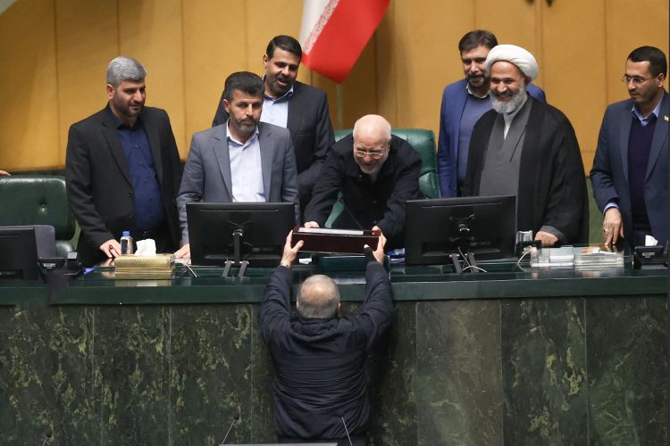 Iranian President Masoud Pezeshkian submits the government’s proposed national budget bill for the new year to the parliament’s presidium on December 23, 2025.