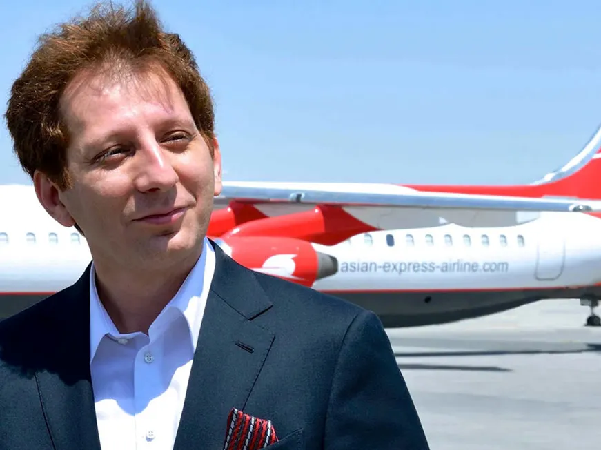 Babak Zanjani in front of a plane belonging to Qeshm Air, the airline he used to own before being jailed