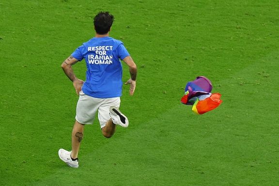 A jimmy jump runs onto the pitch wearing a t-shirt with a message saying 'Respect for Iranian Women' and holding a rainbow flag during the match between Portugal and Uruguay on November 28, 2022.