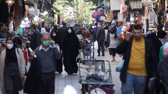 Iranians walk down a market street in Tehran, Iran November 14, 2021.