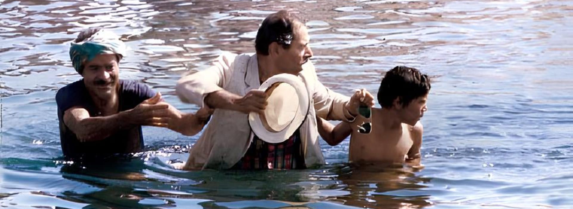 Saeed Poursamimi (left) and Ali Nasirian (center) in a scene from Captain Khorshid (1987)