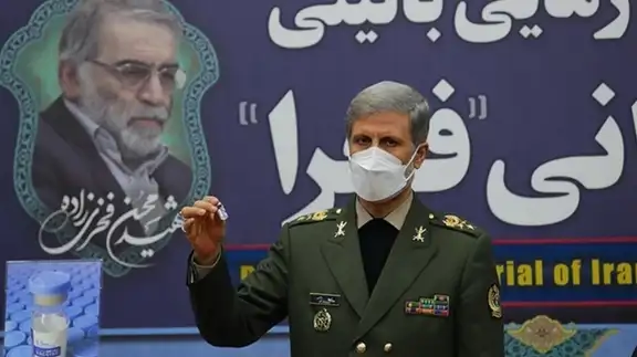 Iranian military commander showing off the Fakhra vaccine said to be developed by the armed forces.