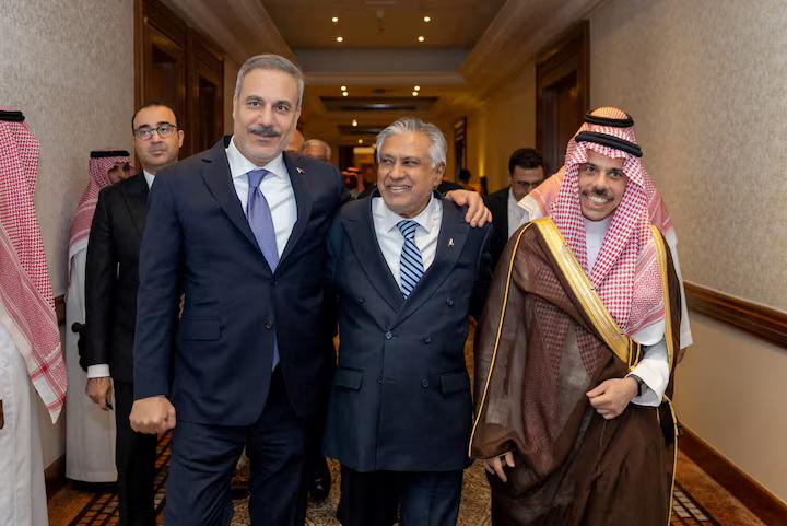 Turkey's Foreign Minister Hakan Fidan, Pakistan's Deputy Prime Minister and Foreign Minister Mohammad Ishaq Dar and Saudi Arabia's Foreign Minister Prince Faisal bin Farhan Al Saud leave after a committee meeting of Mecca defence pact in Riyadh, Saudi Arabia, October 5, 2026. Turkish Foreign Ministry/Handout via REUTERS