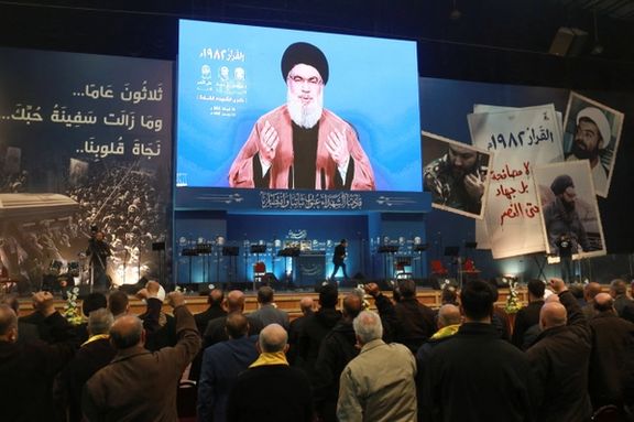 Hezbollah leader Hassan Nasrallah addresses his supporters on screen during a rally in the southern suburbs of Beirut, Lebanon, February 16,