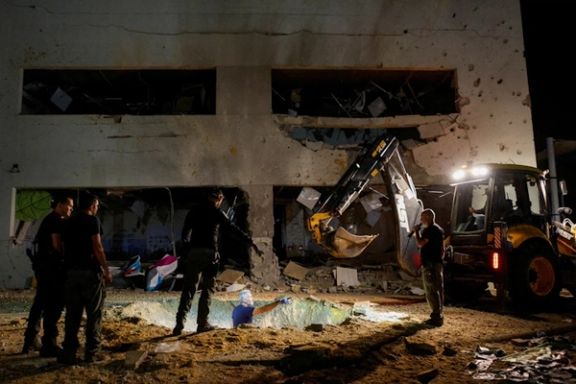 Israeli rescue force members inspect the site where a missile fired from Iran towards Israel hit a school building, in central Israel, October 1, 2024