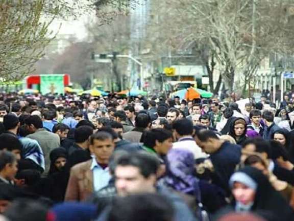 Crowds navigate a busy street in Iran