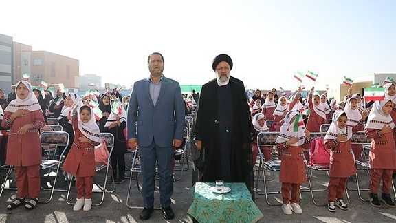 Iran’s Education Minister Reza Morad Sahraei (left) and President Ebrahim Raisi among schoolgirls during a ceremony in Tehran