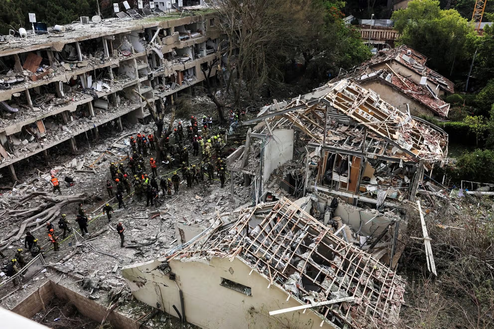 Rescuers and security personnel work at the impacted site after a missile attack from Iran, amid the Iran-Israel conflict in Tel Aviv, Israel June 22, 2025.