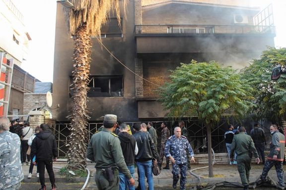 People walk near a damaged site after what the Syrian state news agency said was an Israeli strike in the Damascus suburb of Mazzeh, Syria November 14, 2024.
