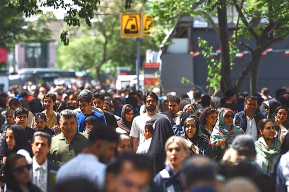 People walk near Tehran's Grand Bazaar, April 21, 2026