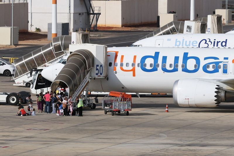 Travelers board a FlyDubai aircraft at Ben Gurion International Airport after a separate FlyDubai flight from the United Arab Emirates to Israel was diverted to Saudi Arabia following an emergency signal, in Lod, near Tel Aviv, Israel, September 30, 2026. REUTERS