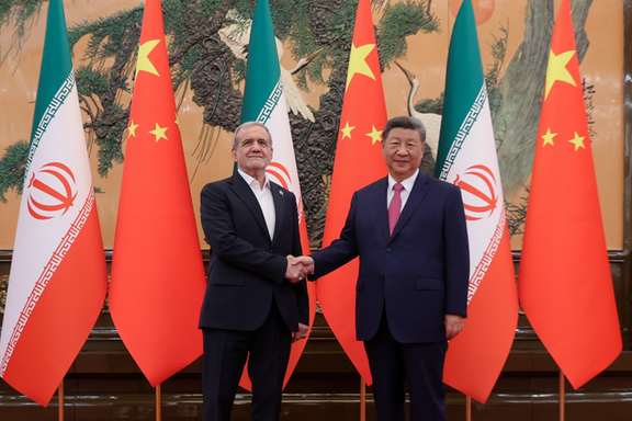Iran's President Masoud Pezeshkian (L) shakes hands with Chinese President Xi Jinping during a meeting in Beijing on September 2, 2025