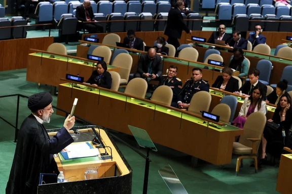 Iran's President Ebrahim Raisi holds up the Quran as he addresses the 78th Session of the UN General Assembly in New York City, September 19, 2023.