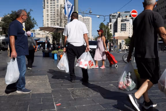 People shop in the main market as Israelis prepare against retaliation by Iran following an Israeli strike, in Jerusalem, June 13, 2025.