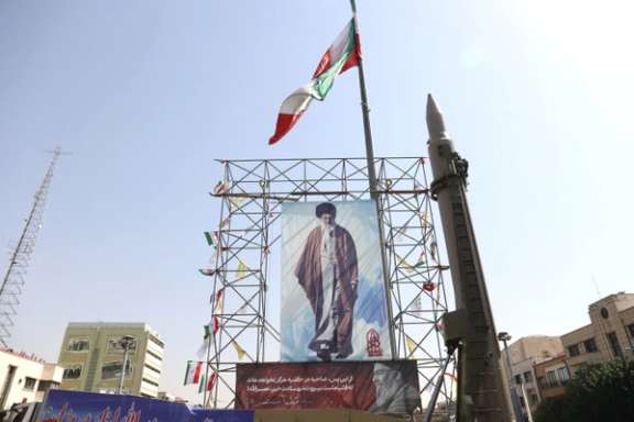 An Iranian missile system is displayed next to a banner with a picture of Iran's Supreme Leader Ayatollah Ali Khamenei and the late Lebanon's Hezbollah leader Hassan Nasrallah, in a street in Tehran, Iran, October 2, 2024.