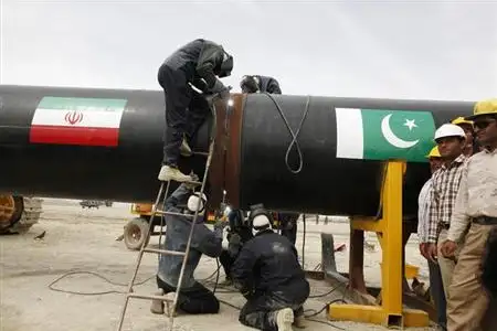 Irani workers weld the pipeline during a groundbreaking ceremony to mark the inauguration of the Iran-Pakistan gas pipeline, in the city of Chabahar in southeastern Iran March 11, 2013.