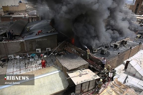 Smoke billows from the fire at a glue storehouse in Tehran on June 6, 2023