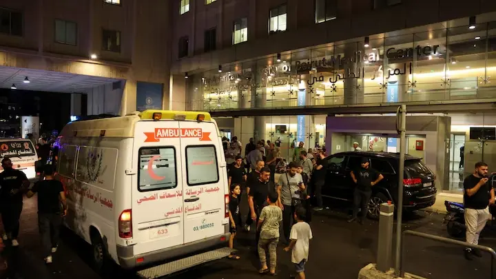 People walk near an ambulance outside American University of Beirut Medical Center (AUBMC) as people, including Hezbollah fighters and medics, were wounded and killed when the pagers they use to communicate exploded across Lebanon, according to a security source, in Beirut, Lebanon September 17, 2024.