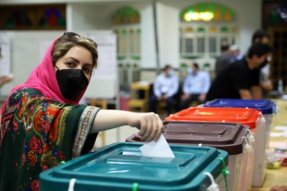 An Iranian woman casts her vote during the presidential election at a polling station in Tehran, Iran June 18, 2021.
