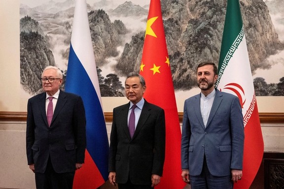 Russian Deputy Foreign Minister Sergei Ryabkov, Chinese Foreign Minister Wang Yi and Iranian Deputy Foreign Minister Kazem Gharibabadi pose for a photo as they meet on March 14, 2025 in Beijing, China.