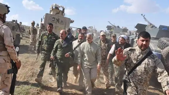 Iran's Qasem Soleimani in Iraq with pro-Iran Shiite militia. Undated