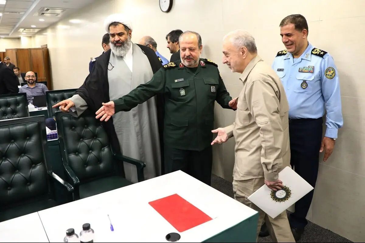 Iran's new Defense Minister Mehrdad Akhlaghi Ketabchi (right) is welcomed by acting Defense Minister Majid Ebn al-Reza during a meeting with senior military officials.