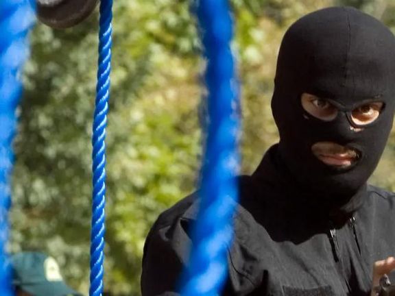 An executioner in Iran preparing a public hanging