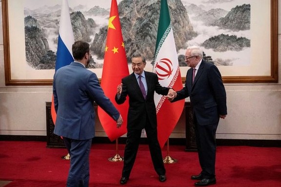 Chinese Foreign Minister Wag Yi welcomes Russian and Iranian deputy foreign ministers Sergey Ryabkov and Kazeem Gharibabadi on March 14, 2025 in Beijing, China.