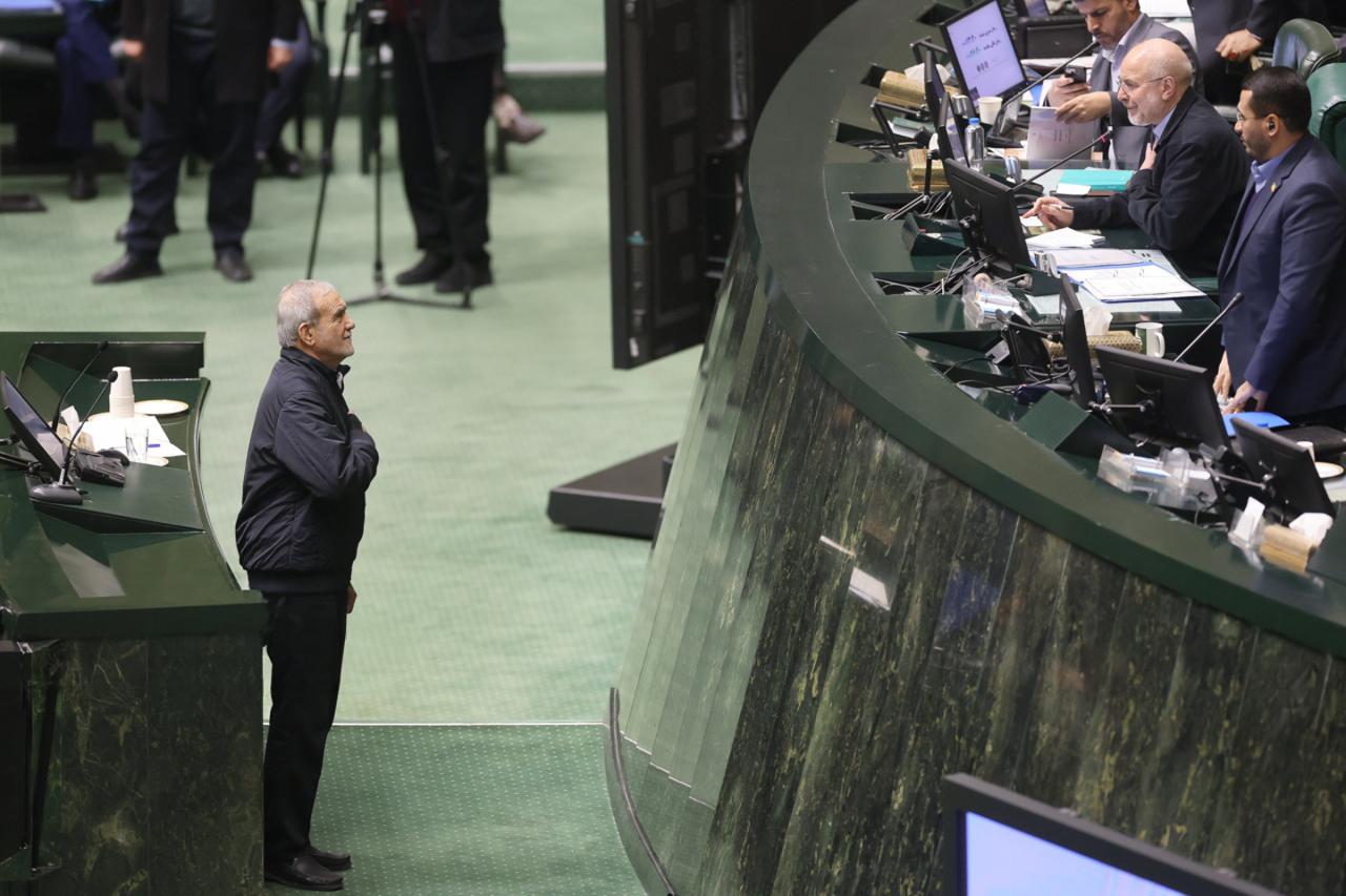 Iranian President Masoud Pezeshkian (left) and Parliament Speaker Mohammad Bagher Ghalibaf during a session of Iran’s parliament in Tehran on December 23, 2025, during which the government submitted the budget bill for the next Iranian year, which starts in March 2026 