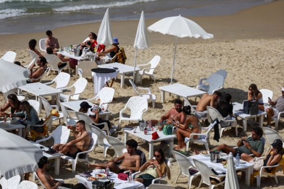 People rest on the beach, after Iran launched drones and missiles towards Israel, in Tel Aviv, Israel, April 14, 2024.