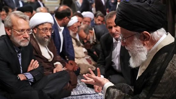 An undated photo showing Khamenei speaking with Larijani in a leadership gathering.