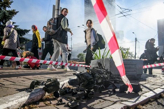 Local residents look at parts of an unmanned aerial vehicle (UAV), what Ukrainian authorities consider to be an Iranian-made drone Shahed-136, after Russian drone strike, amid Russia's attack on Ukraine, in Kyiv, Ukraine October 17, 2022.