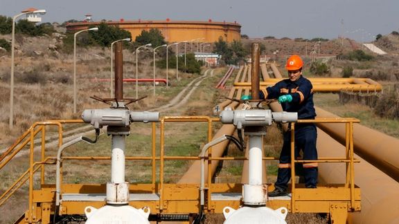 A worker checks the valve gears of pipes linked to oil tanks at Turkey's Mediterranean port of Ceyhan, which is run by state-owned Petroleum Pipeline Corporation (BOTAS), some 70 km (43.5 miles) from Adana February 19, 2014.