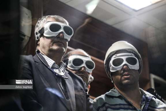 The head of Iran's Atomic Energy Organization, Mohammad Eslami (left), during an exhibition of Iran's nuclear advances in Tehran