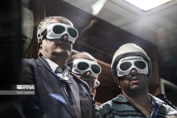 The head of Iran's Atomic Energy Organization, Mohammad Eslami (left), during an exhibition of Iran's nuclear advances in Tehran
