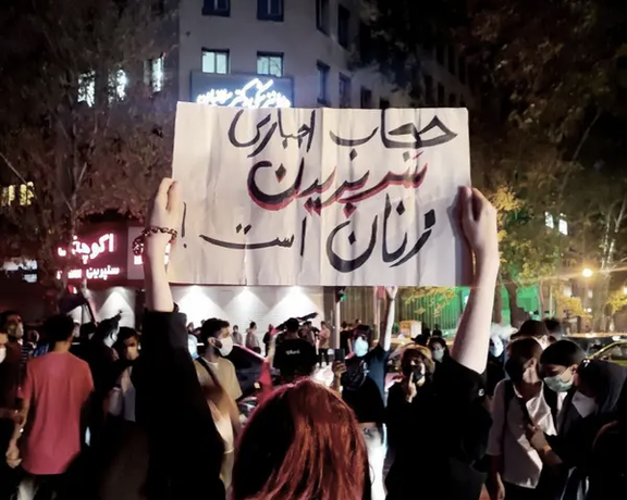 An Iranian woman holding a banner against compulsory hijab