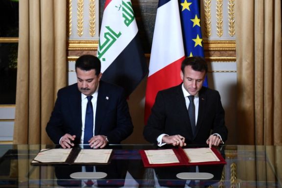 French President Emmanuel Macron and Iraq's Prime Minister Mohammed al-Sudani sign documents at the Elysee Presidential Palace, in Paris, France, January 26, 2023.